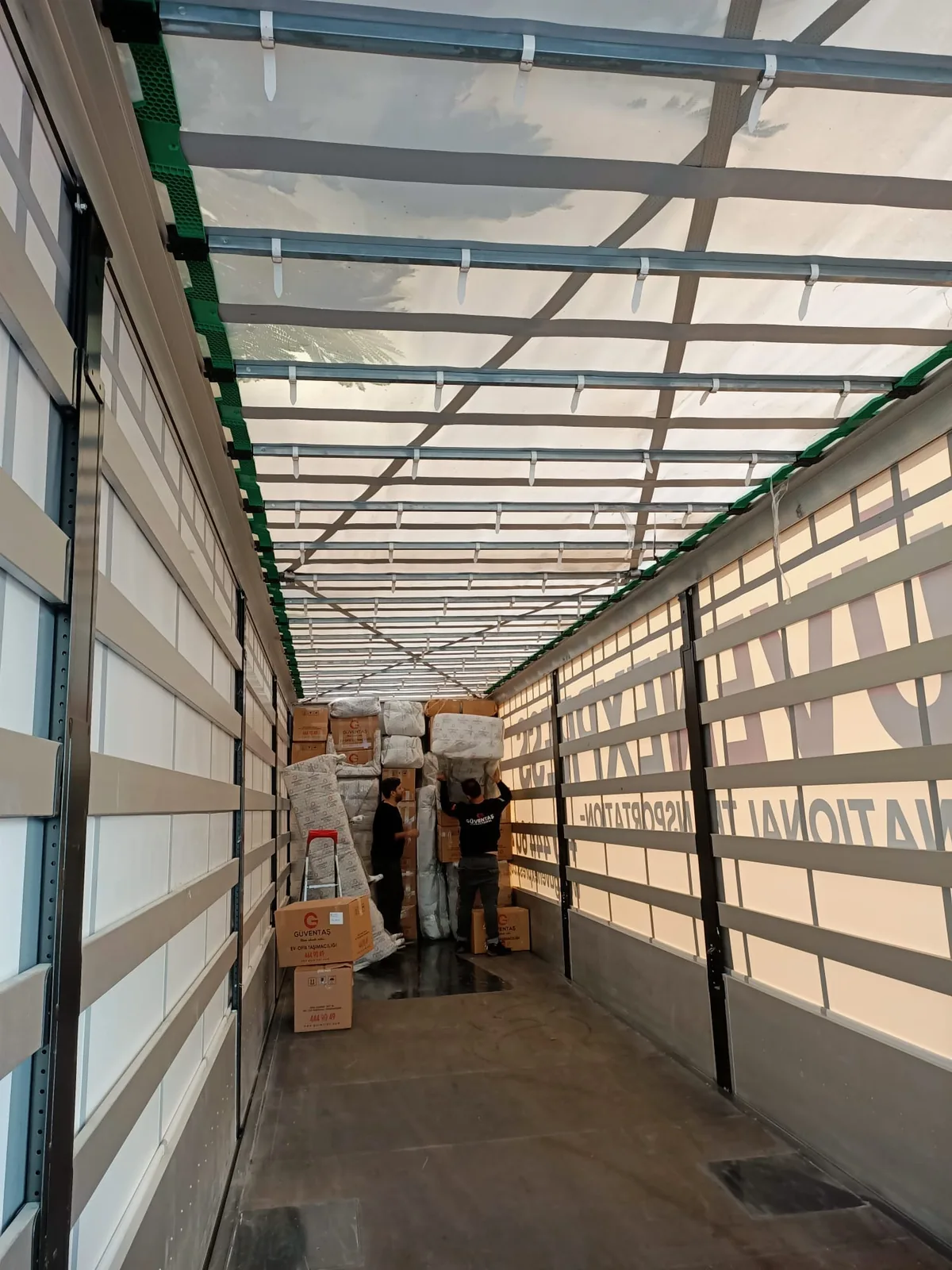 Cargo handling inside a GüvenExpress curtain-side trailer